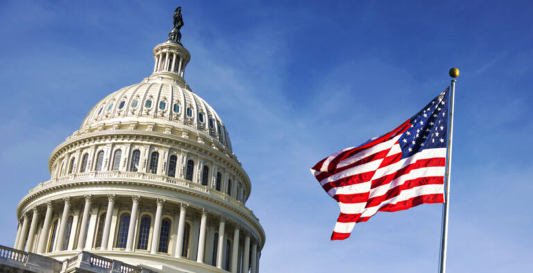 American flag waving with the Capitol Hill