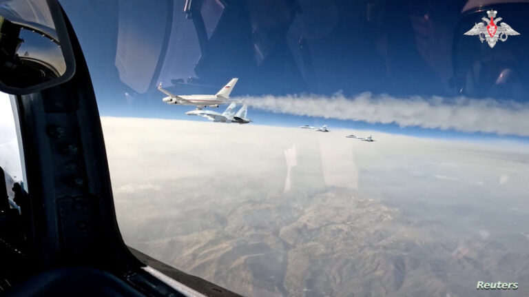 Russian Su-35S combat aircraft escort Russian President Putin's plane heading to United Arab Emirates
