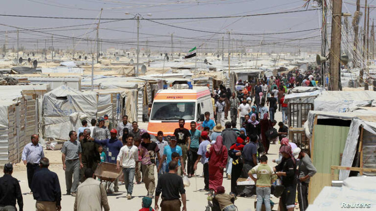 Syrian refugees walk at Al Zaatri refugee camp in the Jordanian city of Mafraq, near the border with Syria