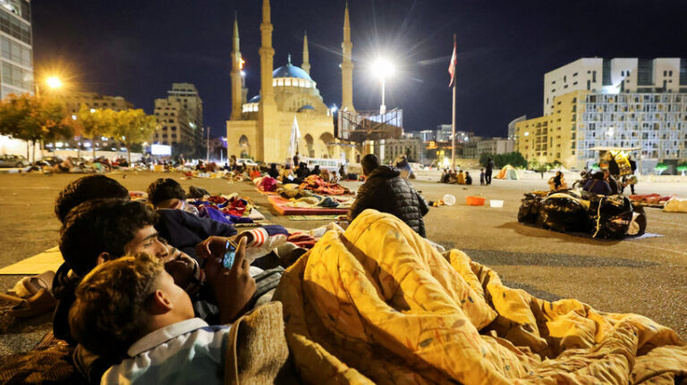 Displaced people rest in their temporary shelter at Martyrs' Square in the city centre, where many people spend the night fleeing the ongoing Israeli strikes in southern Beirut