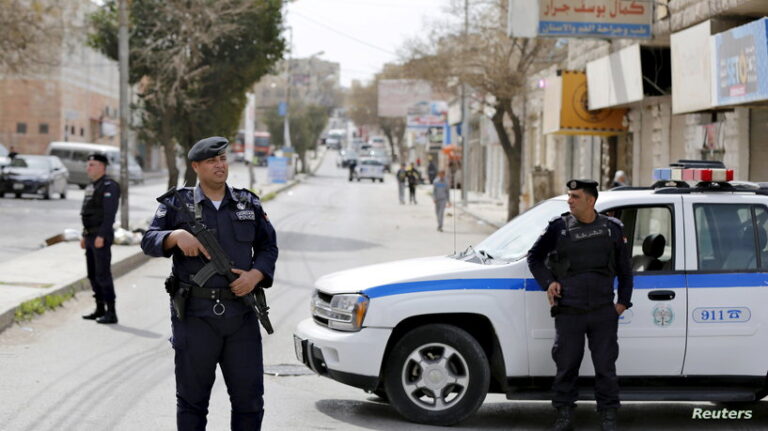 Officers of the Jordanian public security department stand guard in the northern city of Irbid